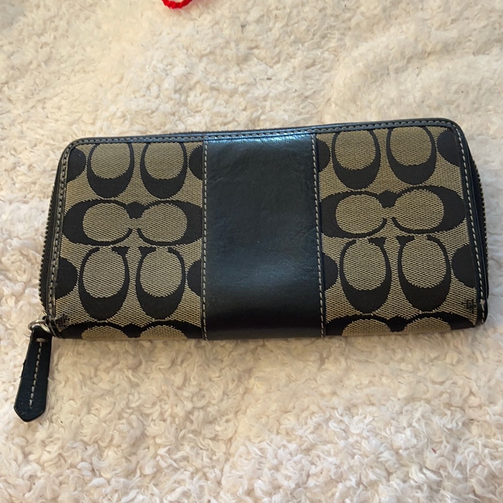 Coach navy blue outside and lavender insider zipper wallet.